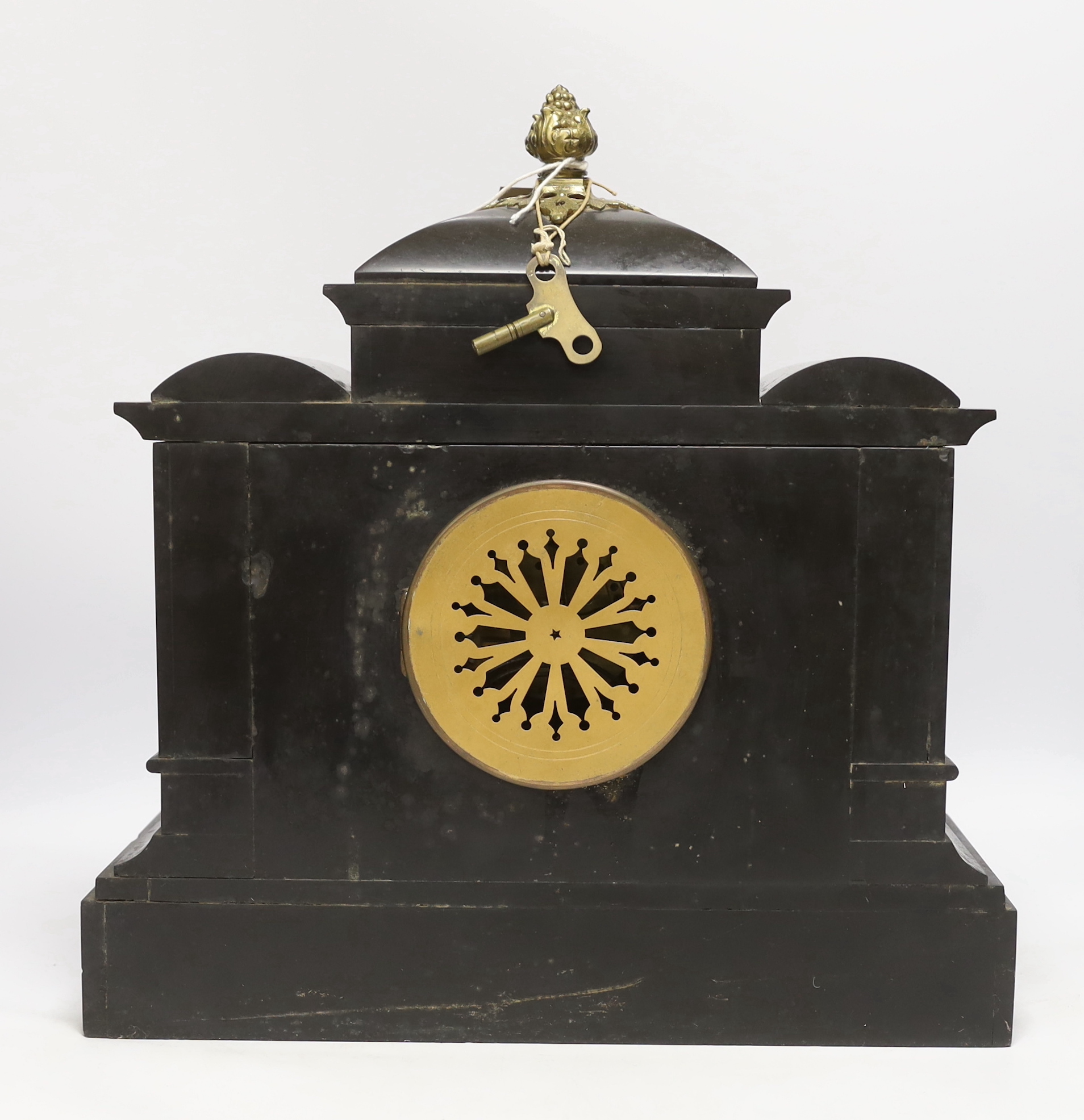 A black slate mantel clock with gilded pillars, striking on a coiled gong, 41cm high